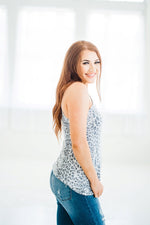 Short sleeve single shoulder top in grey & white leopard side view.