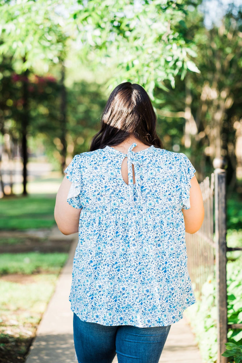 tiered ruffle sleeve top in blue and teal small on white base floral back view plus size