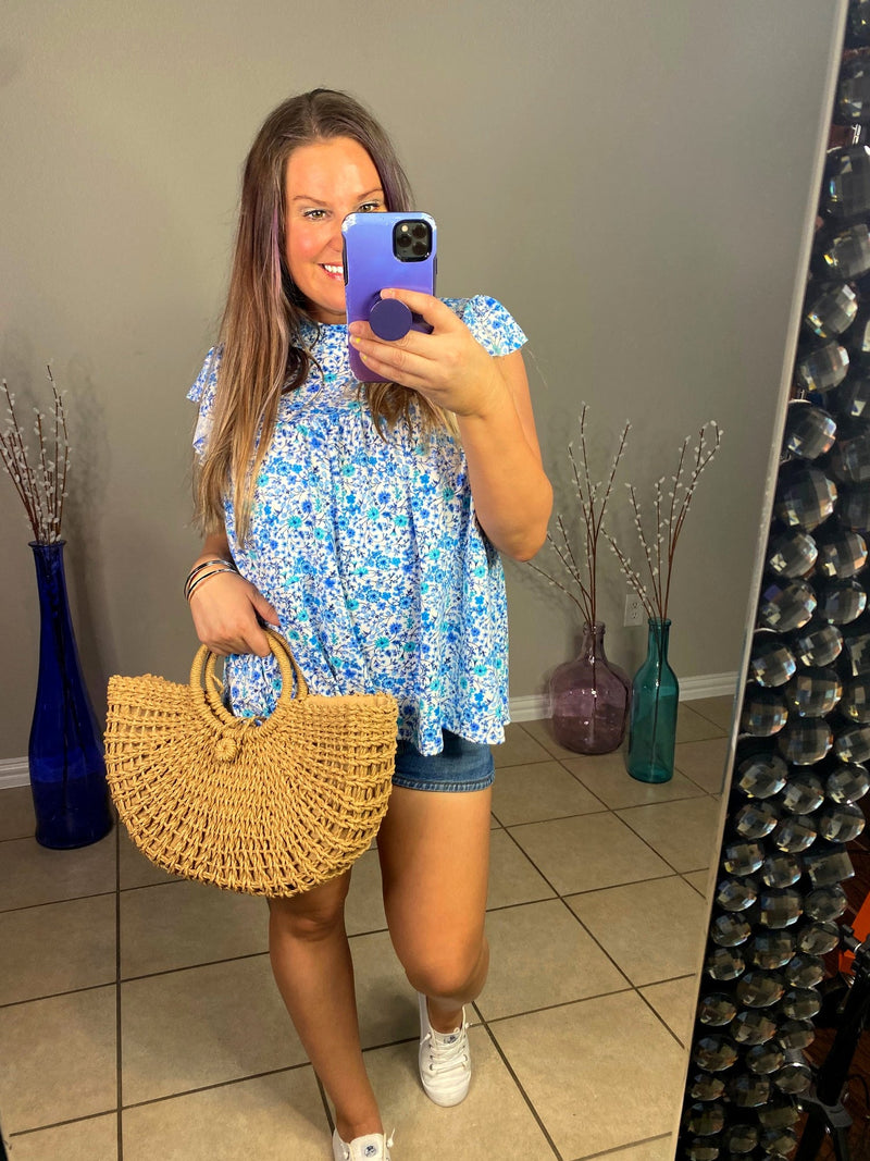 tiered ruffle sleeve top in blue and teal small on white base floral front view selfie with handbag